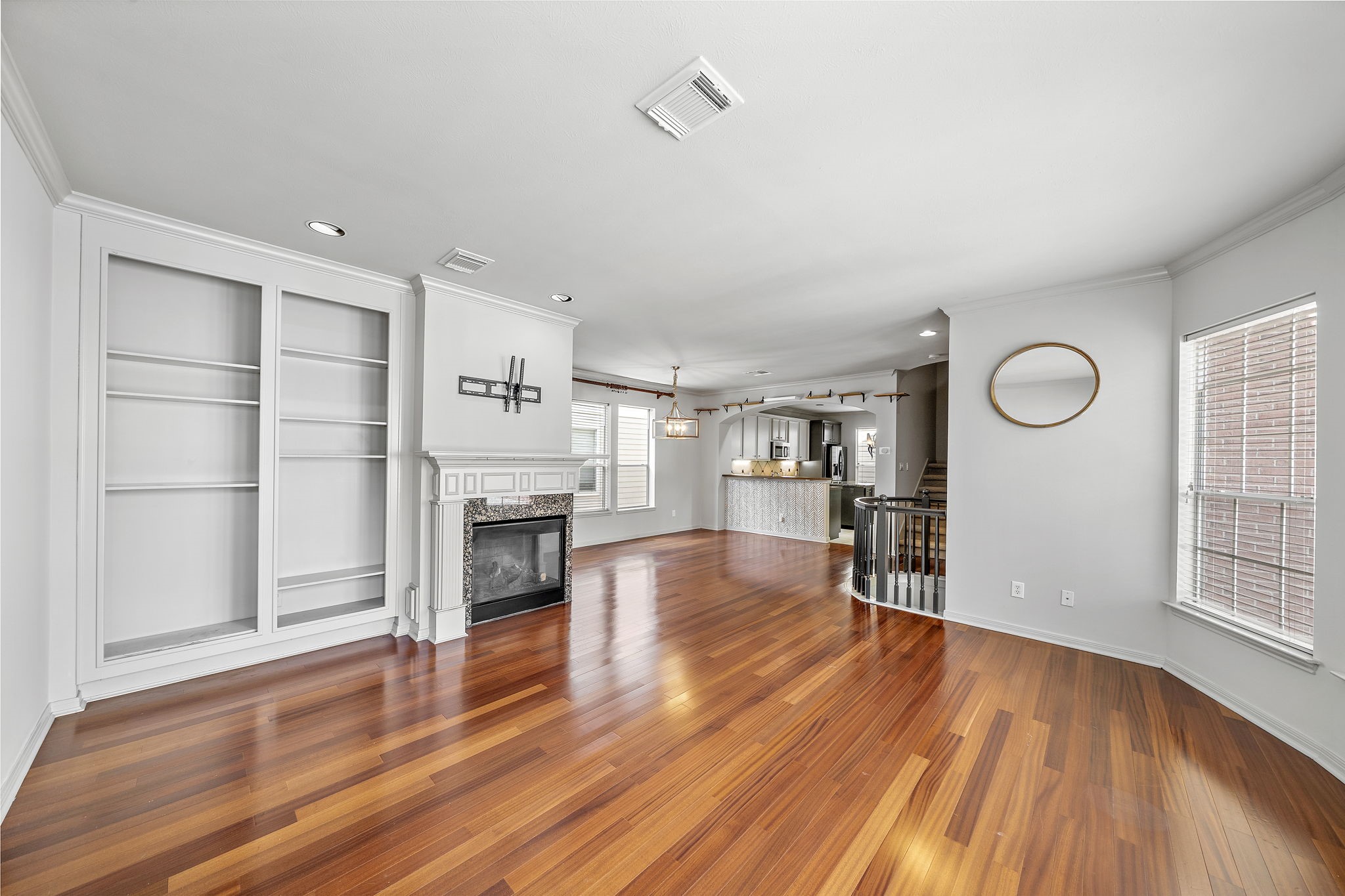 1429 Oneil Street Houston, TX 77019 - Photo 6 of 23 an empty room with wooden floor fireplace and windows