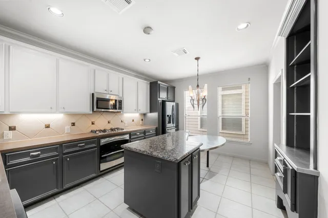 a kitchen with stainless steel appliances granite countertop a stove and a sink