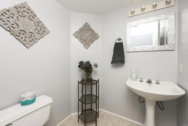 a bathroom with a sink mirror and toilet