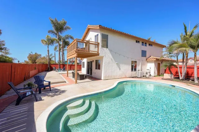 a swimming pool with outdoor seating yard and patio