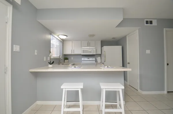 a kitchen with a sink a stove a refrigerator and cabinets