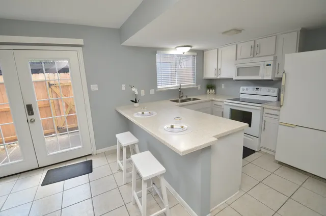 a kitchen with sink stove and cabinets