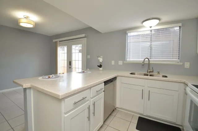 a kitchen with a stove cabinets and a sink