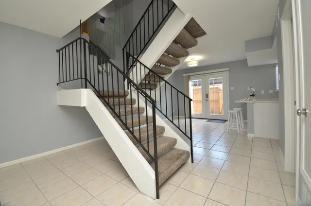 a view of staircase and kitchen with sink