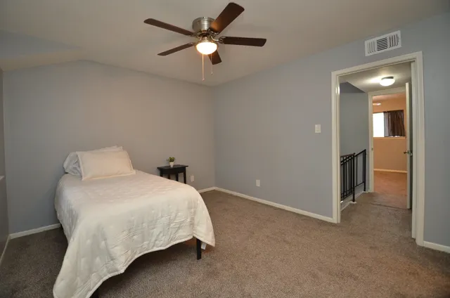 a small space with a wooden floor and a window