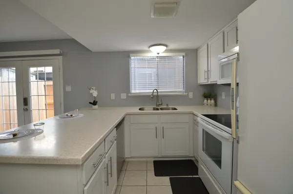 a kitchen with a sink stove and cabinets