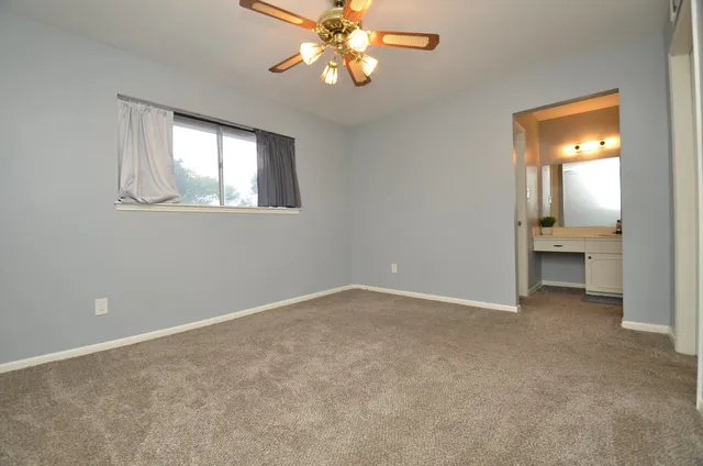 an empty room with windows and entrance