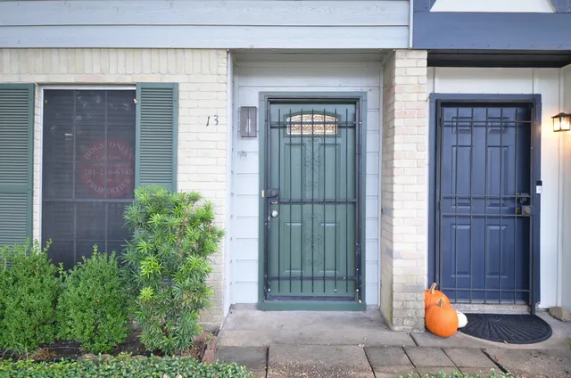 a backyard of a house with sofas table and chairs