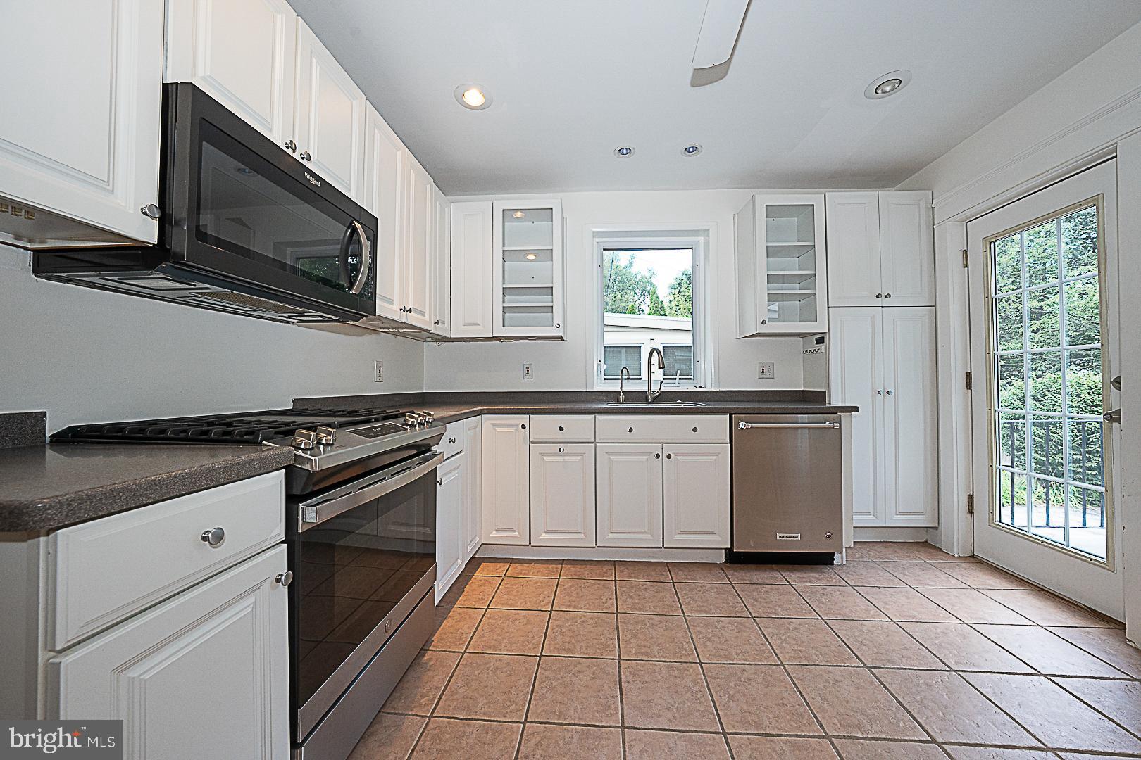 507 Homewood Avenue Narberth, PA 19072 - Photo 12 of 31 a kitchen with stainless steel appliances a sink dishwasher stove and white cabinets