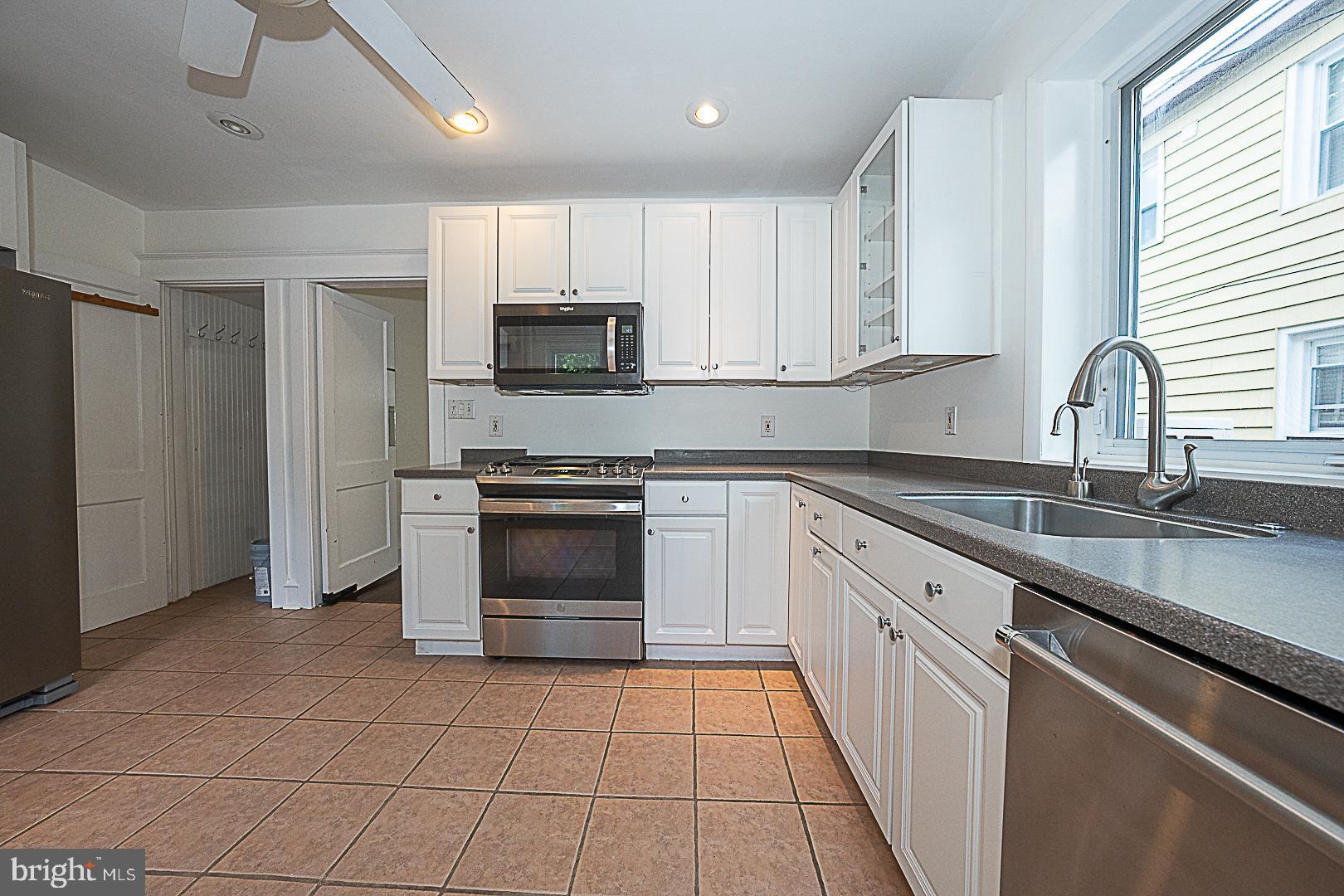 507 Homewood Avenue Narberth, PA 19072 - Photo 13 of 31 a kitchen with kitchen island granite countertop a stove sink and microwave