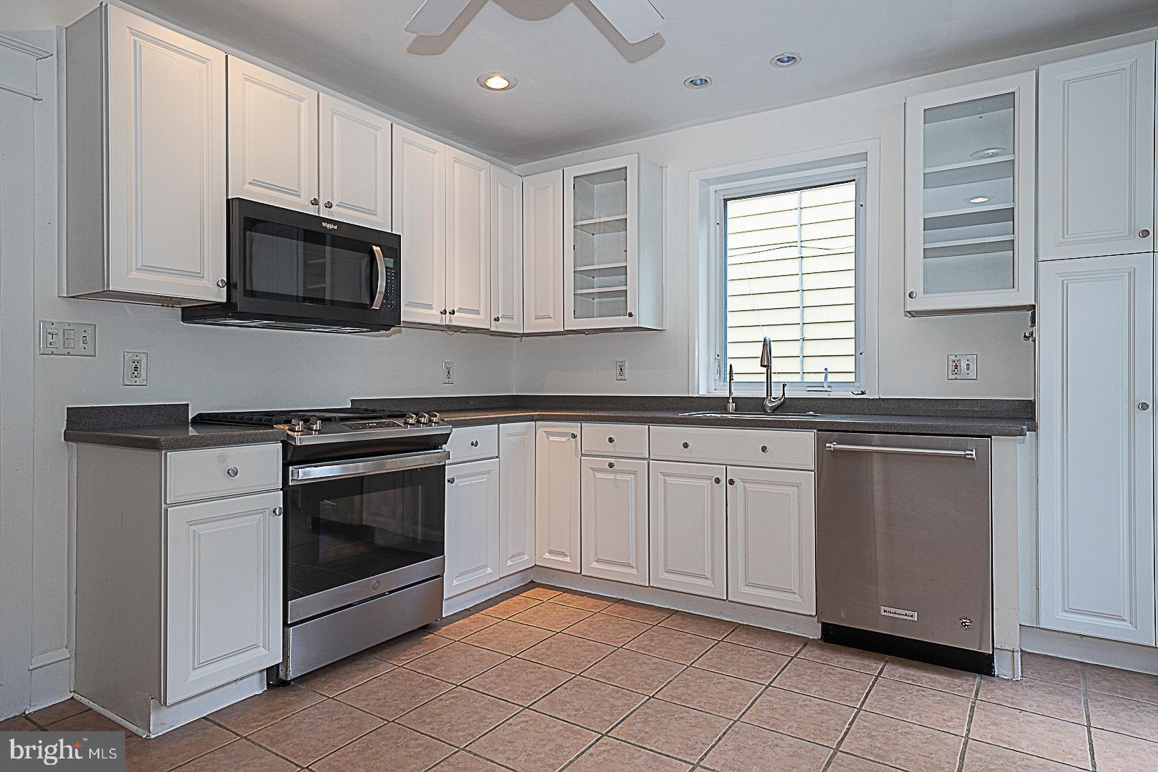 507 Homewood Avenue Narberth, PA 19072 - Photo 15 of 31 a kitchen with granite countertop white cabinets stainless steel appliances and a sink