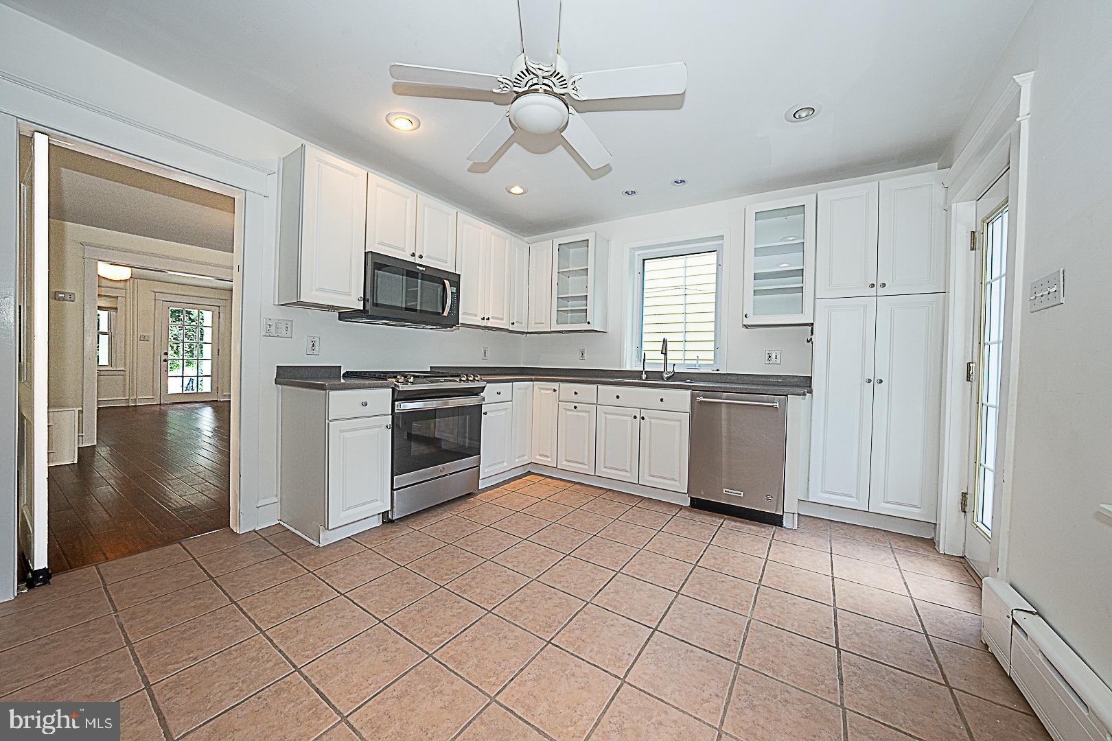 507 Homewood Avenue Narberth, PA 19072 - Photo 16 of 31 a kitchen with stainless steel appliances granite countertop a stove top oven a sink and cabinets