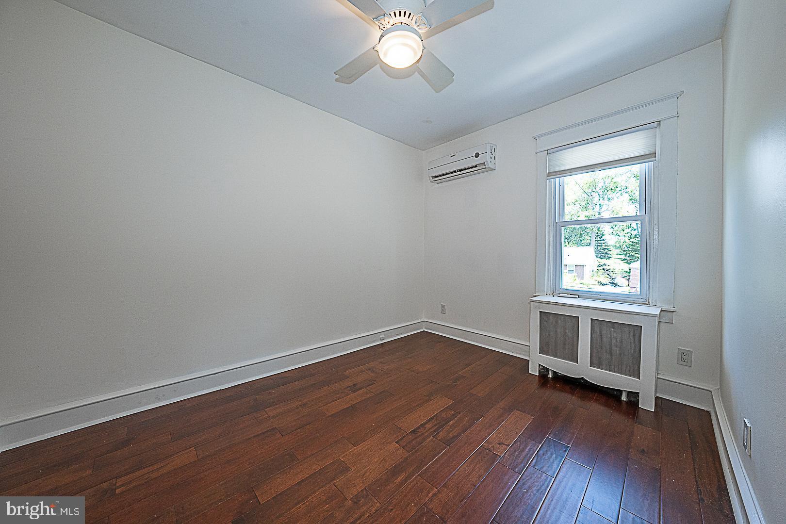507 Homewood Avenue Narberth, PA 19072 - Photo 19 of 31 an empty room with wooden floor and windows
