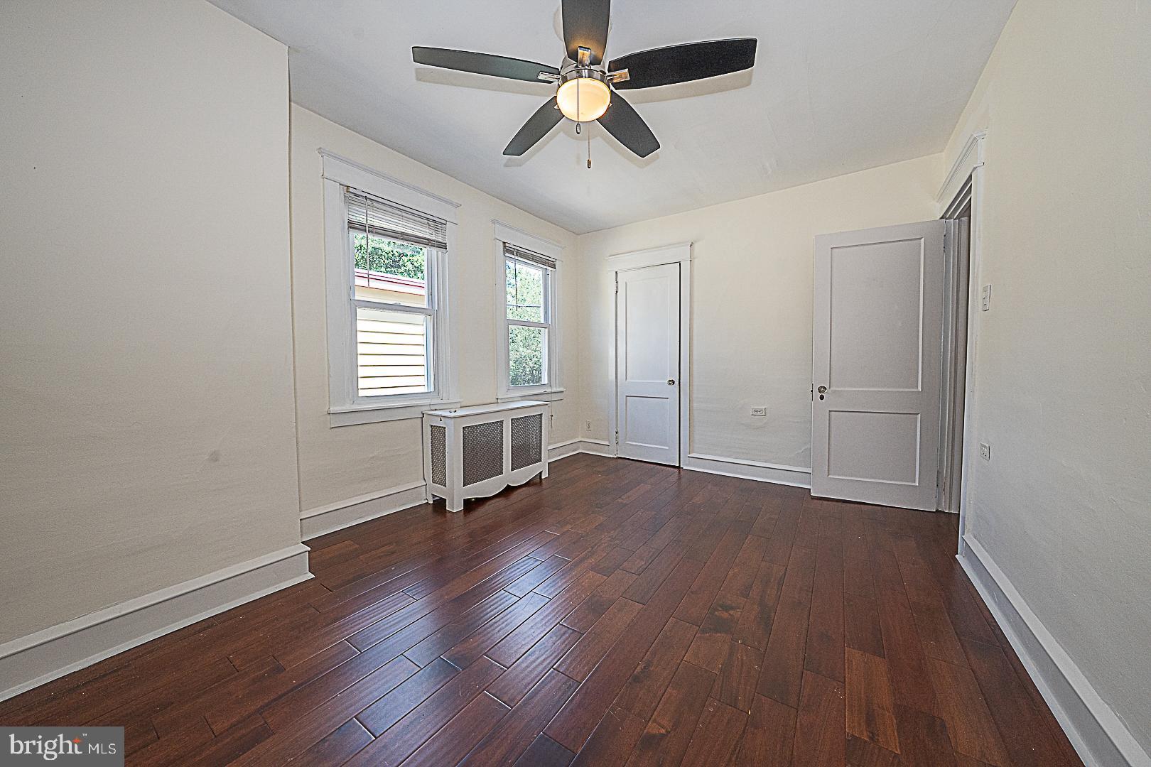 507 Homewood Avenue Narberth, PA 19072 - Photo 21 of 31 an empty room with wooden floor ceiling fan and windows