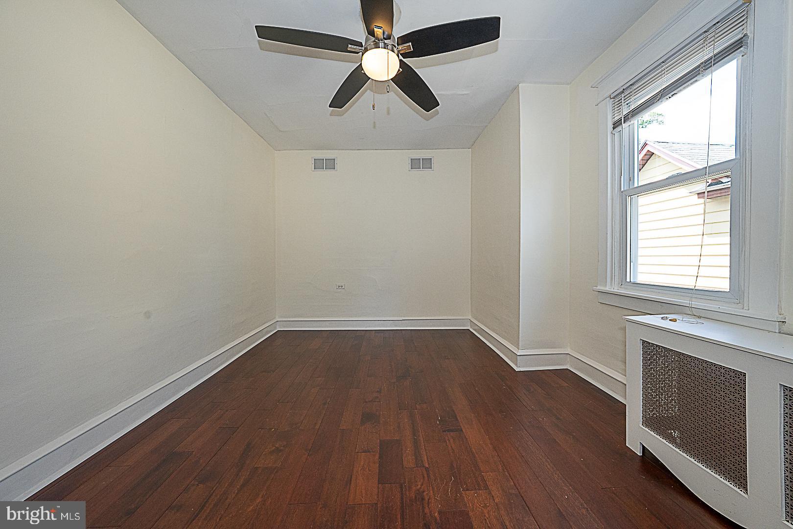 507 Homewood Avenue Narberth, PA 19072 - Photo 22 of 31 an empty room with wooden floor chandelier fan and windows