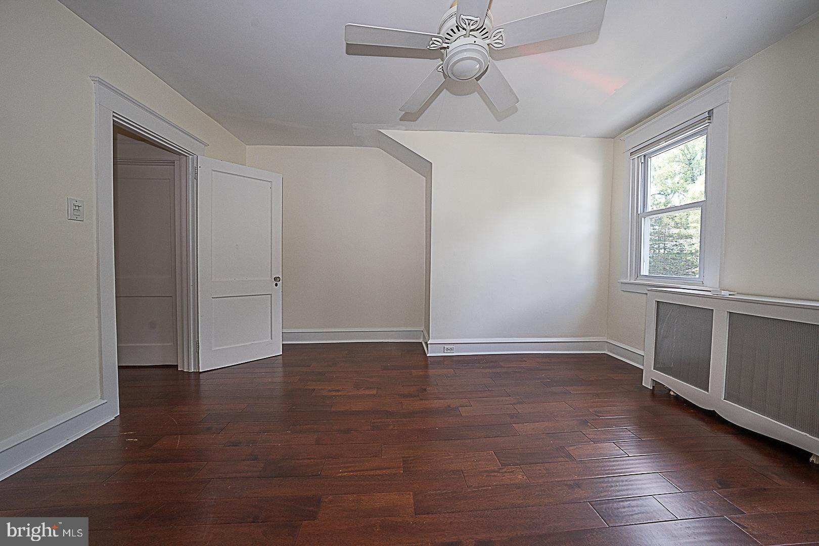 507 Homewood Avenue Narberth, PA 19072 - Photo 24 of 31 an empty room with wooden floor chandelier fan and windows
