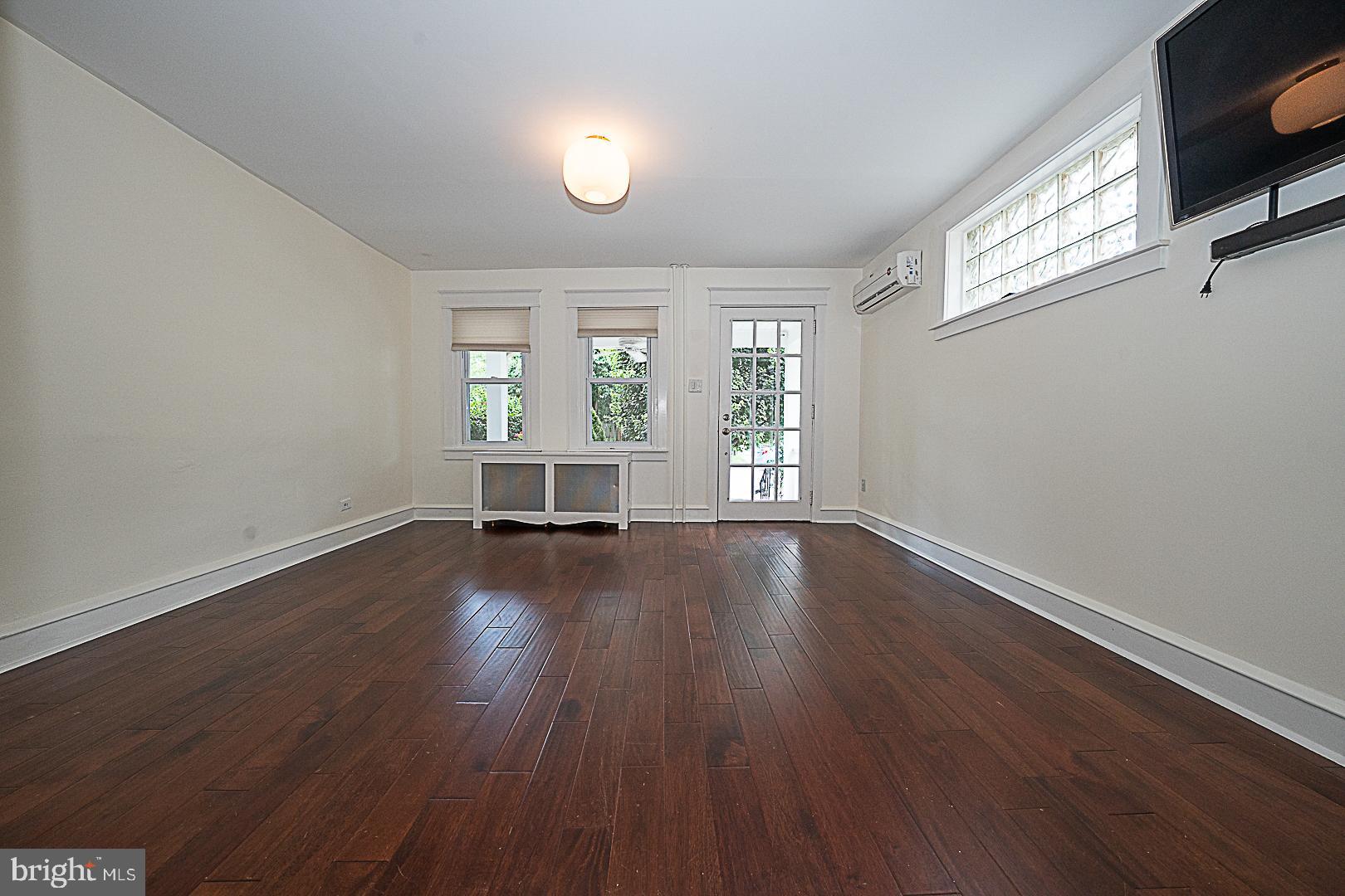 507 Homewood Avenue Narberth, PA 19072 - Photo 8 of 31 an empty room with wooden floor and windows