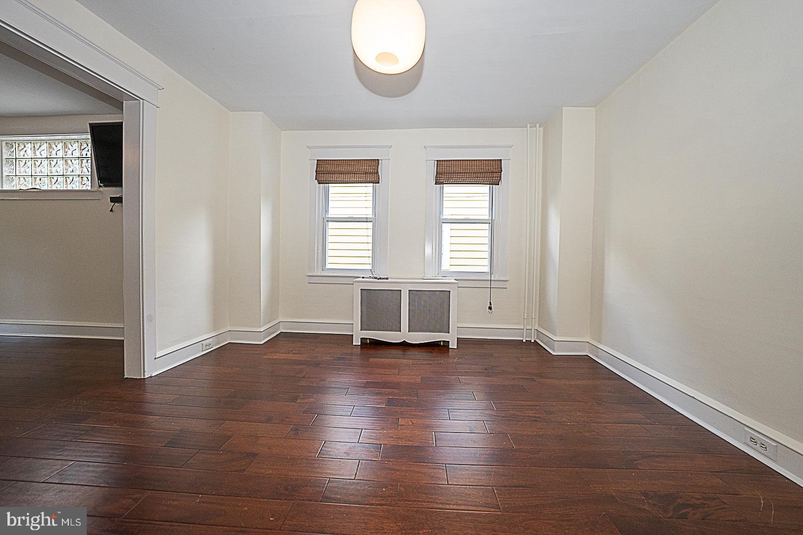 507 Homewood Avenue Narberth, PA 19072 - Photo 9 of 31 an empty room with wooden floor and windows