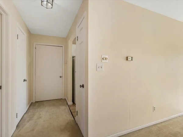 a spacious bedroom with a large bed and a large window