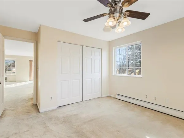 an empty room with a empty space and a ceiling fan