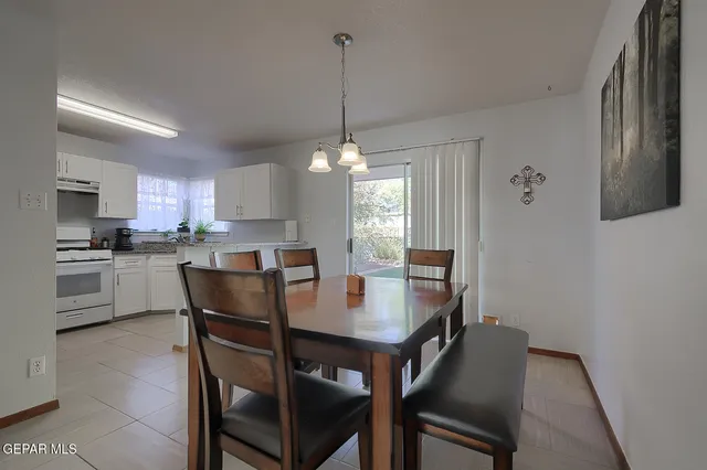 a dining room with furniture and window