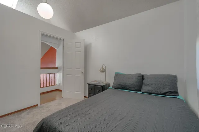 a bedroom with a bed and cabinets