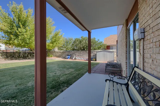 a view of a porch with chairs and backyard