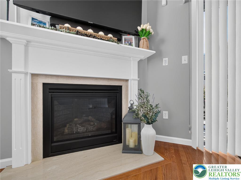 4148 Ross Road Bethlehem, PA 18020 - Photo 28 of 67 Elegant fireplace featuring a classic white mantel, providing a focal point to the richly toned hardwood flooring.