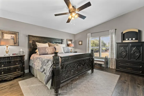 a bedroom with a bed and a ceiling fan