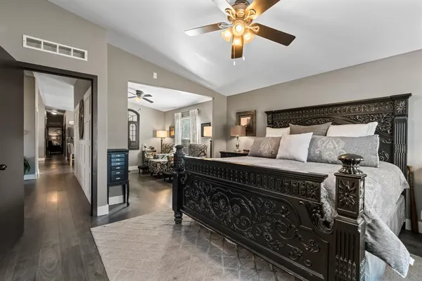 a bedroom with a bed and a chandelier