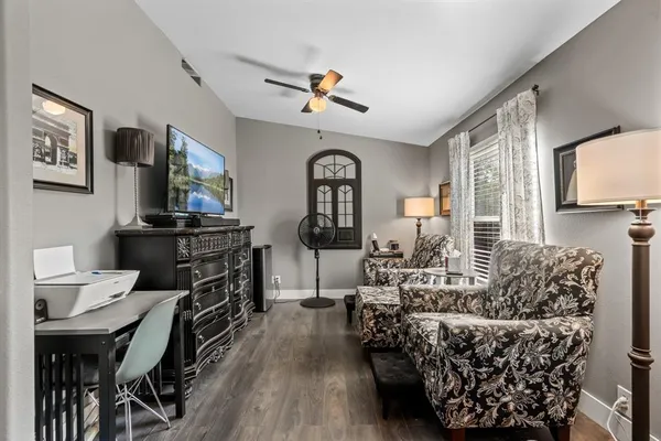 a living room with furniture and wooden floor