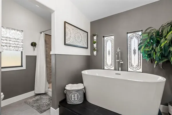 a white bath tub sitting next to a white toilet