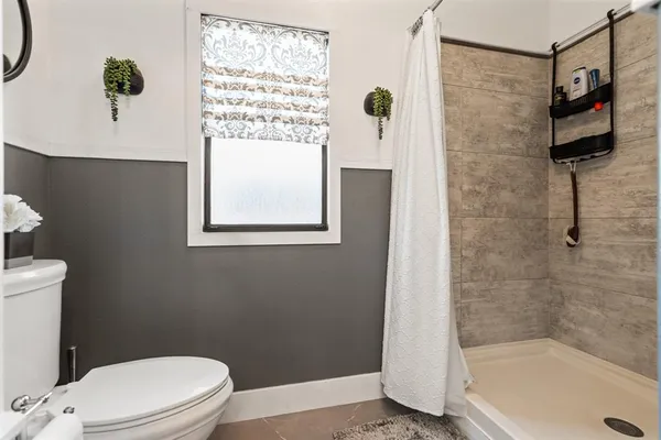 a bathroom with a toilet and a shower