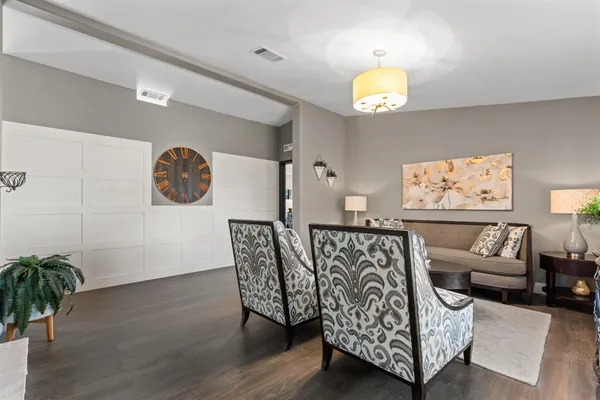 a living room with furniture and a chandelier