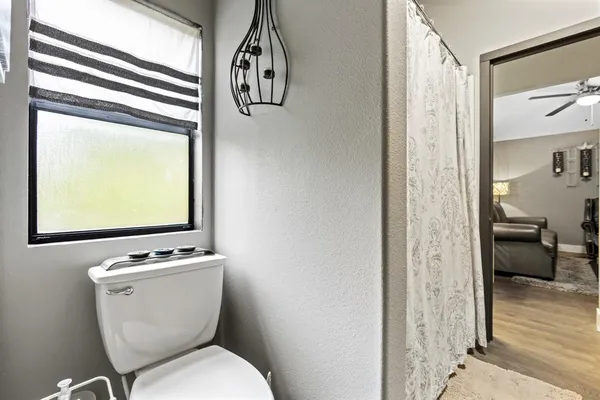 a white toilet sitting next to a bathroom sink