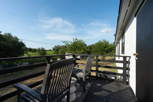 a view of balcony with wooden floor and outdoor seating