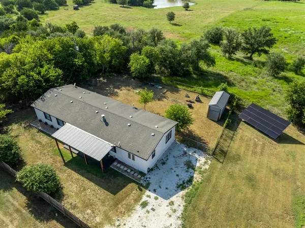 an aerial view of a house with yard swimming pool and outdoor seating