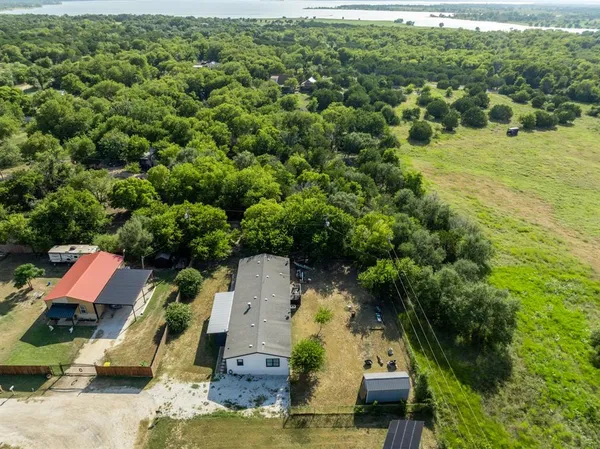 an aerial view of a house with a yard
