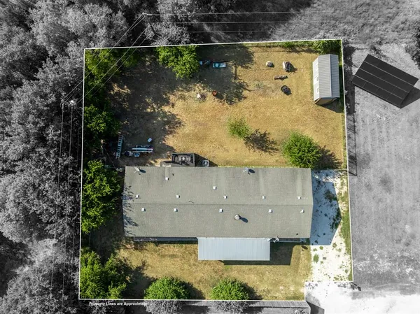 an aerial view of a house with a yard