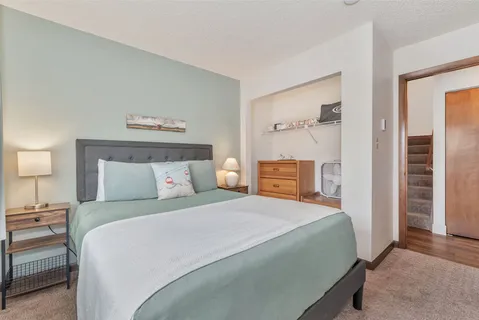a bedroom with a bed and large window
