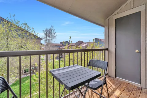 a view of a balcony with wooden floor