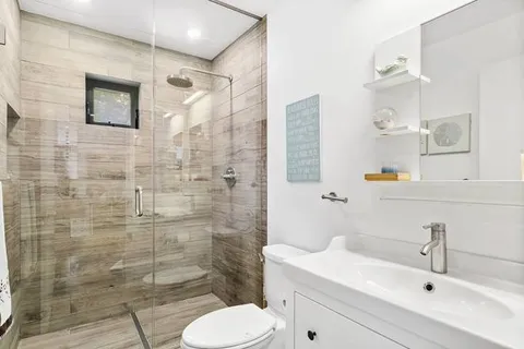 a bathroom with a sink toilet and shower