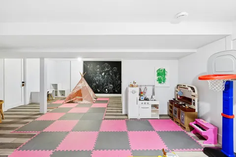 a room with gym equipment and a rug