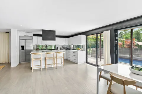 a open kitchen with white cabinets and stainless steel appliances