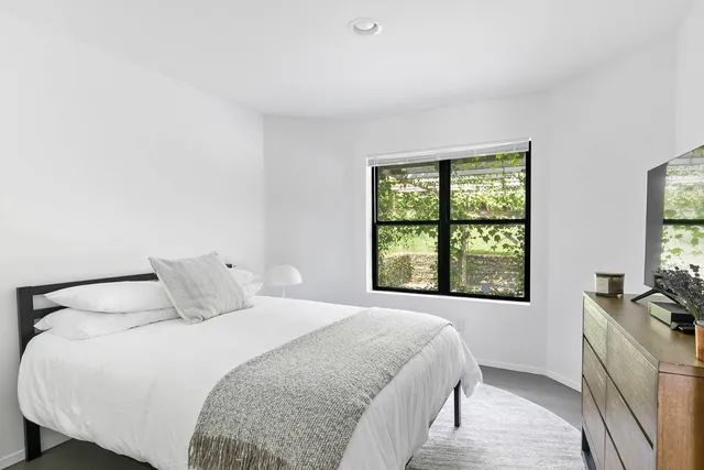 a bedroom with a bed and a window