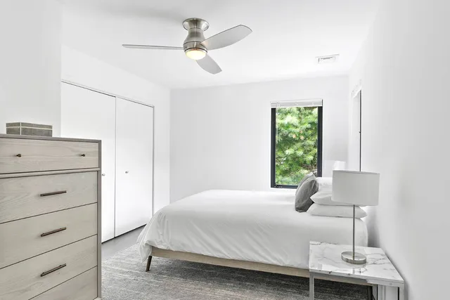 a bedroom with a bed and a window