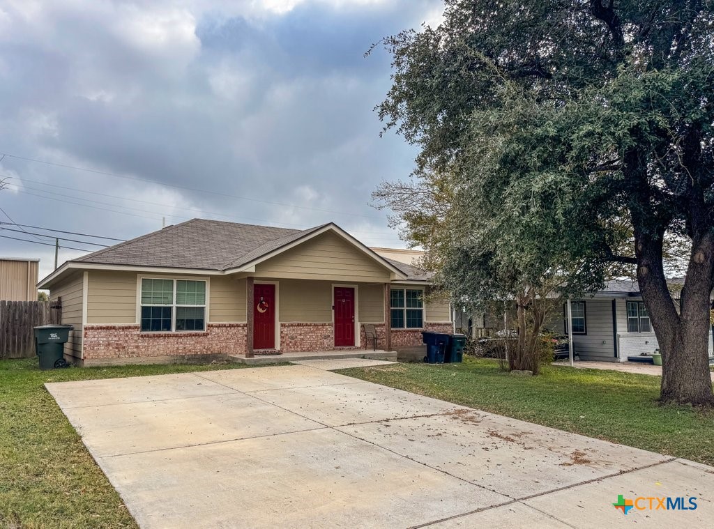 113 South 41st Street Temple, TX 76504 - Photo 3 of 18 a front view of a house with a yard and trees