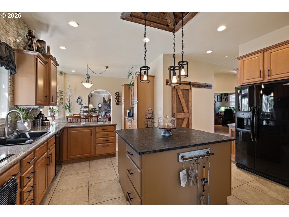 500 St Hilaire Road Yakima, WA 98901 - Photo 4 of 29 a kitchen with stainless steel appliances kitchen island a refrigerator and a sink