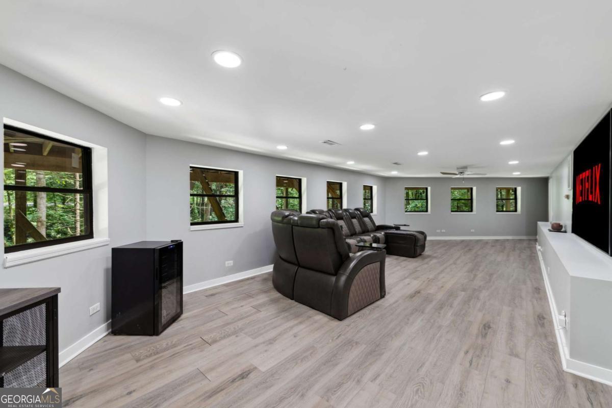 10323 Grassy Mountain Road Ellijay, GA 30540 - Photo 22 of 70 a living room with furniture and a wooden floor