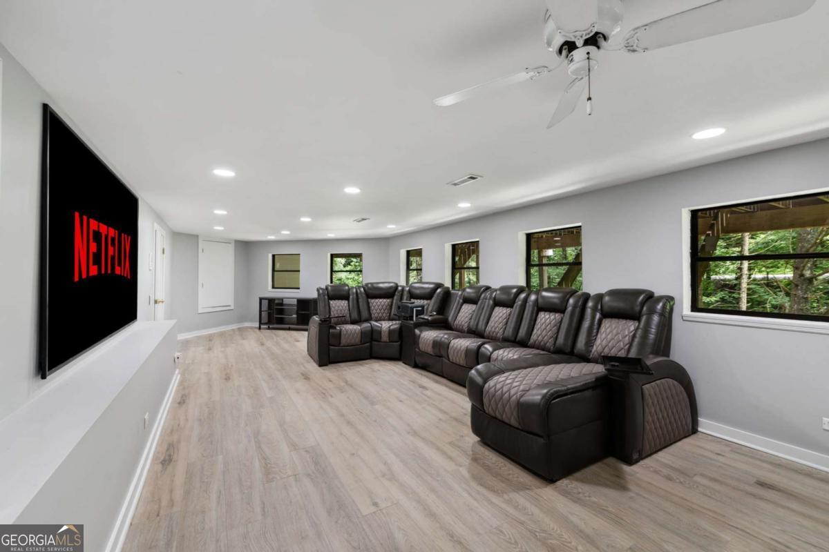 10323 Grassy Mountain Road Ellijay, GA 30540 - Photo 23 of 70 a living room with furniture and a flat screen tv